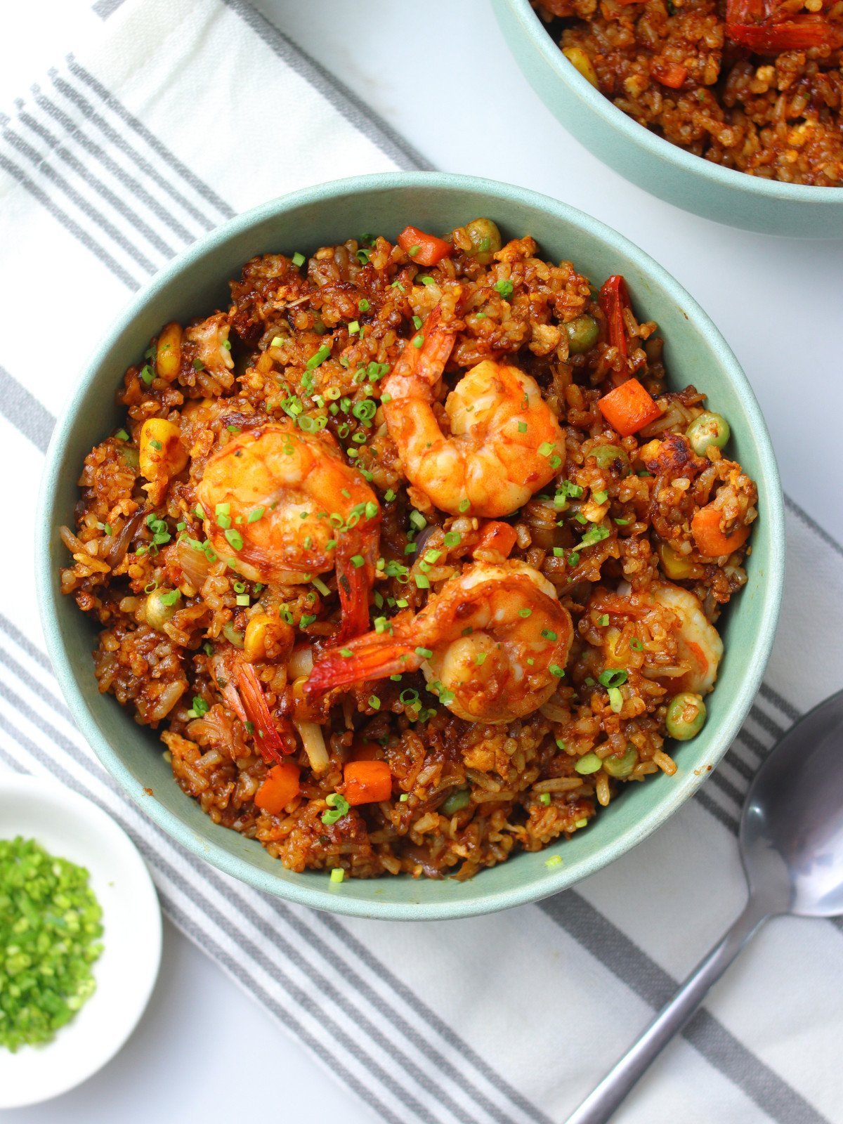 Chinese prawn fried rice in a green bowl.