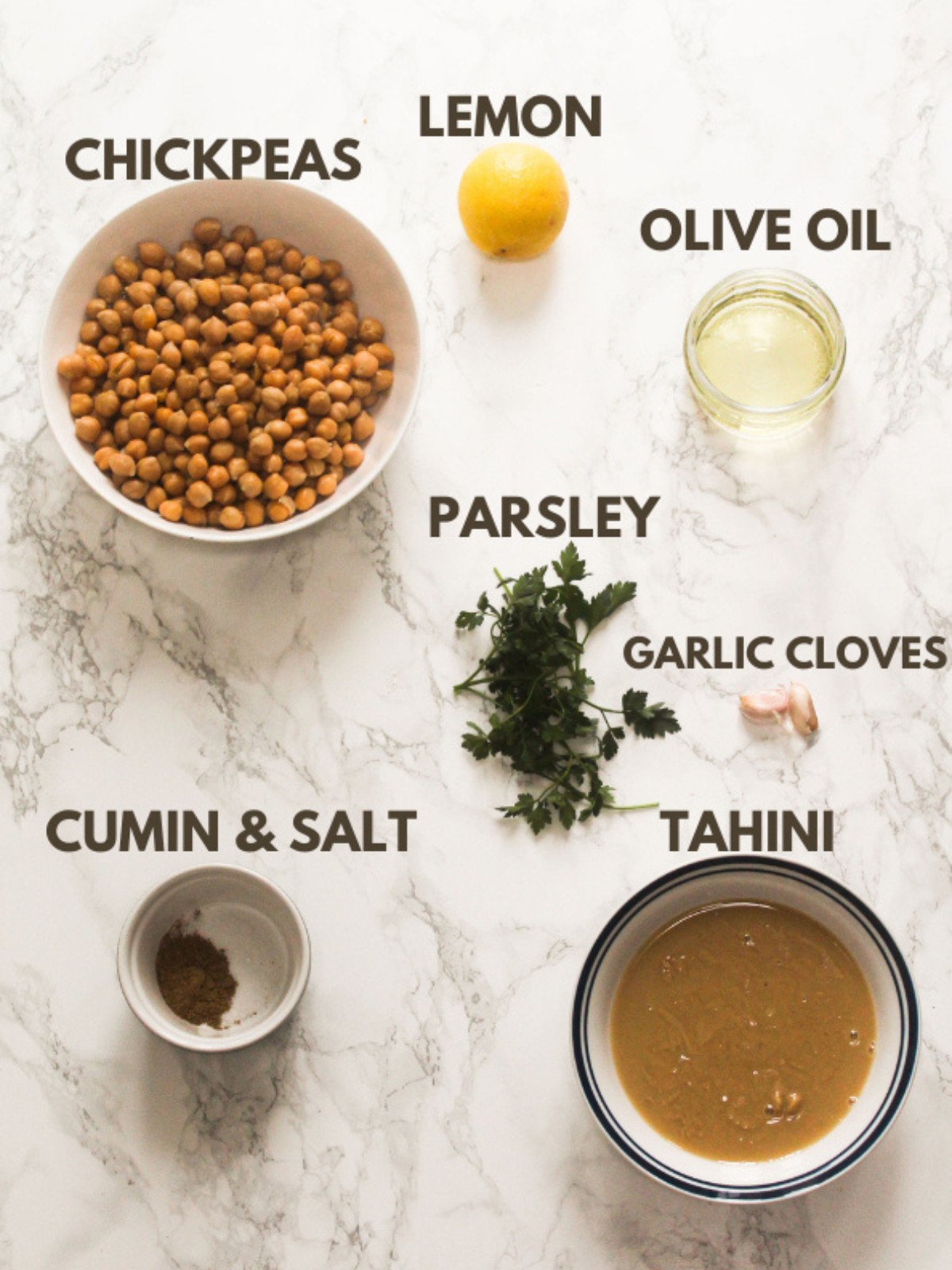 Chickpeas, lemon, olive oil, tahini, garlic, cumin, salt and parsley.