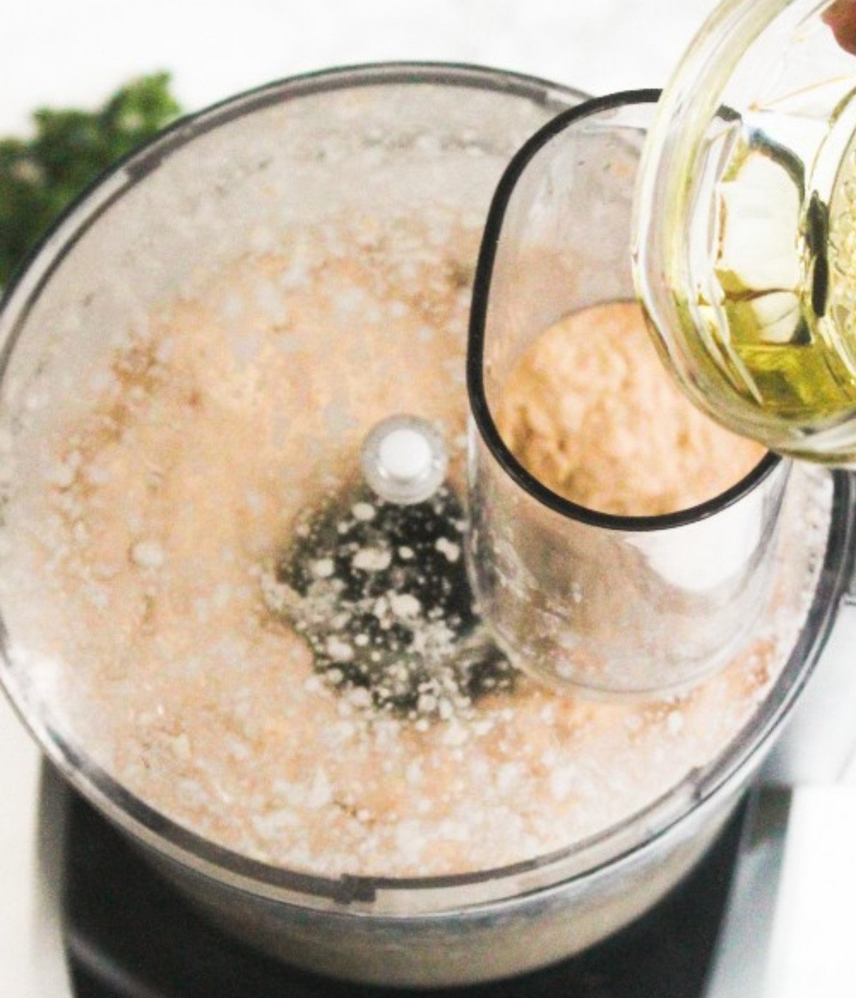 Hummus and olive oil mixed in a food processor.