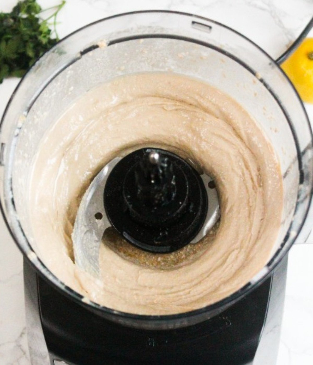 Whipped tahini and lemon juice in a food processor.