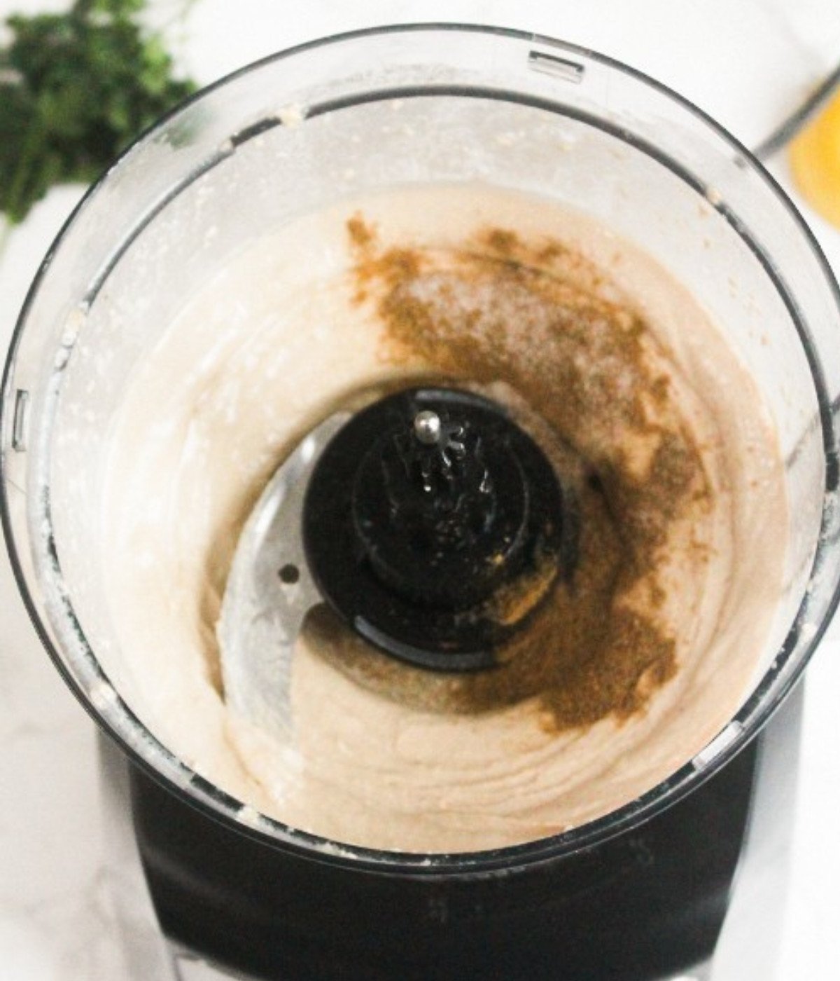 Whipped tahini, lemon juice, cumin and salt in a food processor.