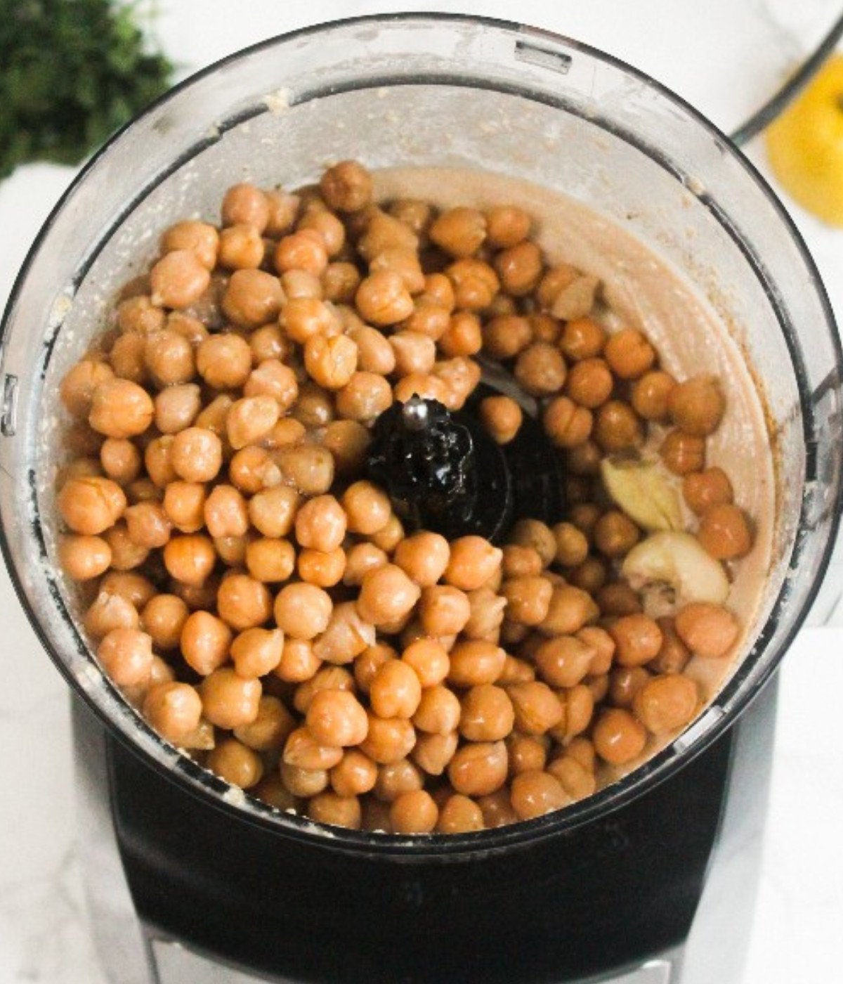 Whipped tahini, lemon juice, cumin, chickpeas, garlic and salt in a food processor.