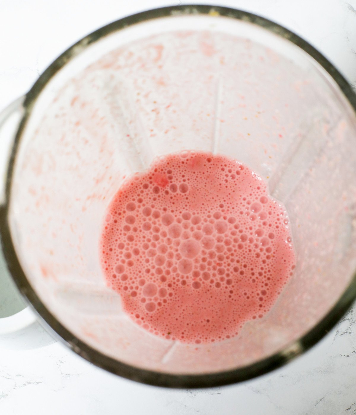 Frozen strawberries, oats and milk, honey blended in a smoothie maker.
