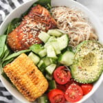Salmon, noodles, sweetcorn, cucumber, tomato and avocado.