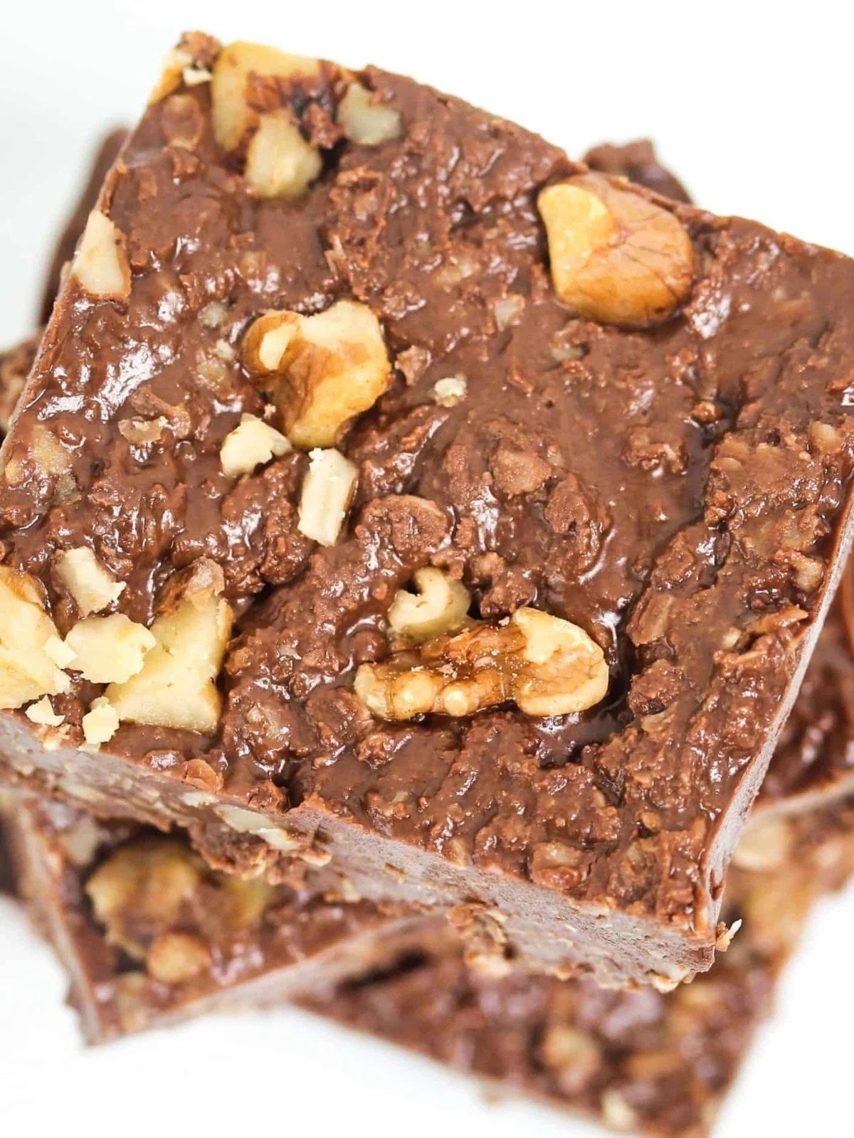 Chocolate oat bars with walnuts stacked.