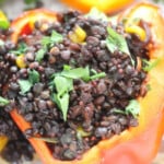 Black lentil beans, corn and fresh herbs in capsicum peppers.