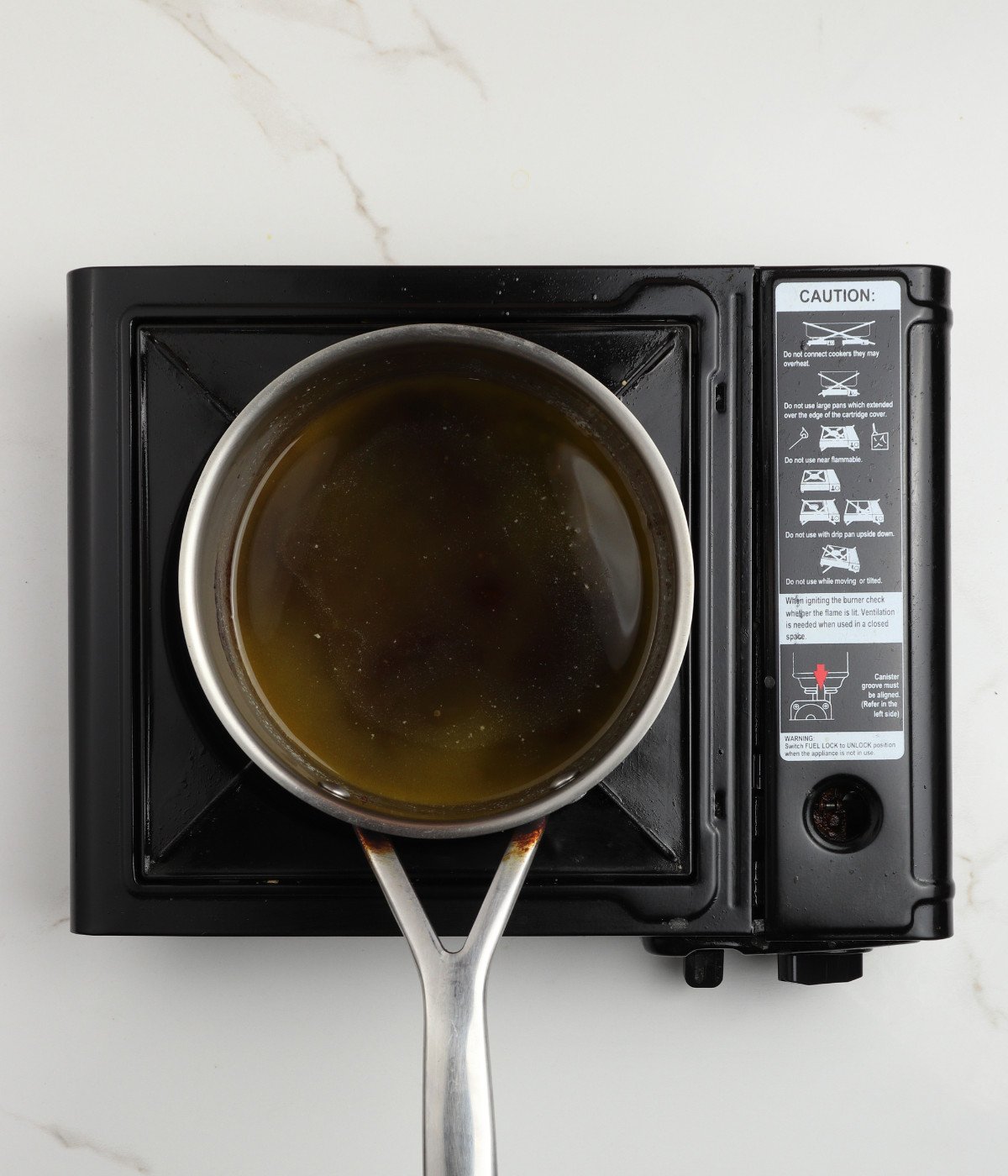 Butter and sugar mixed in a pot.