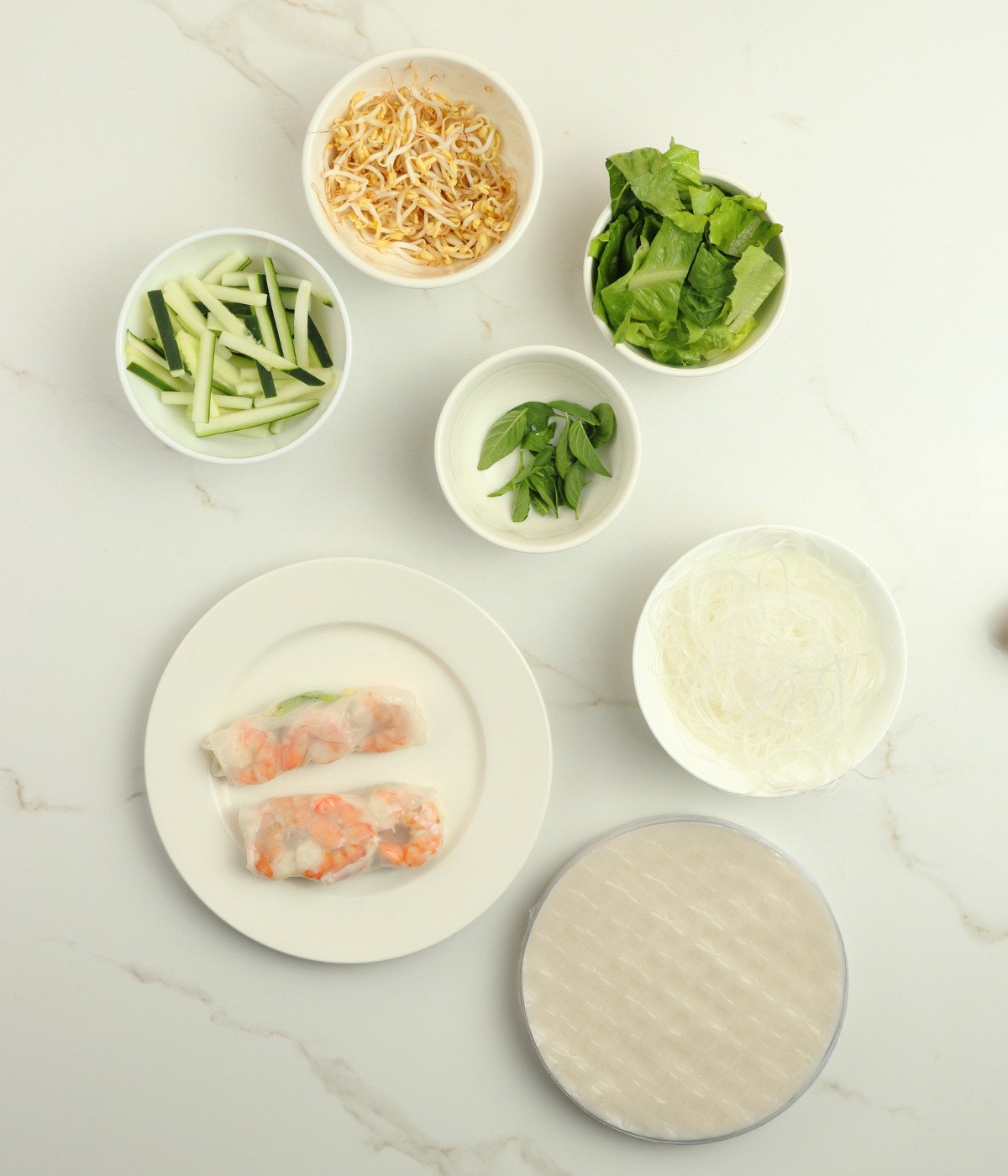 Prawns, beans sprouts, lettuce, basil, cucumber and noodles in a rice paper sheet.