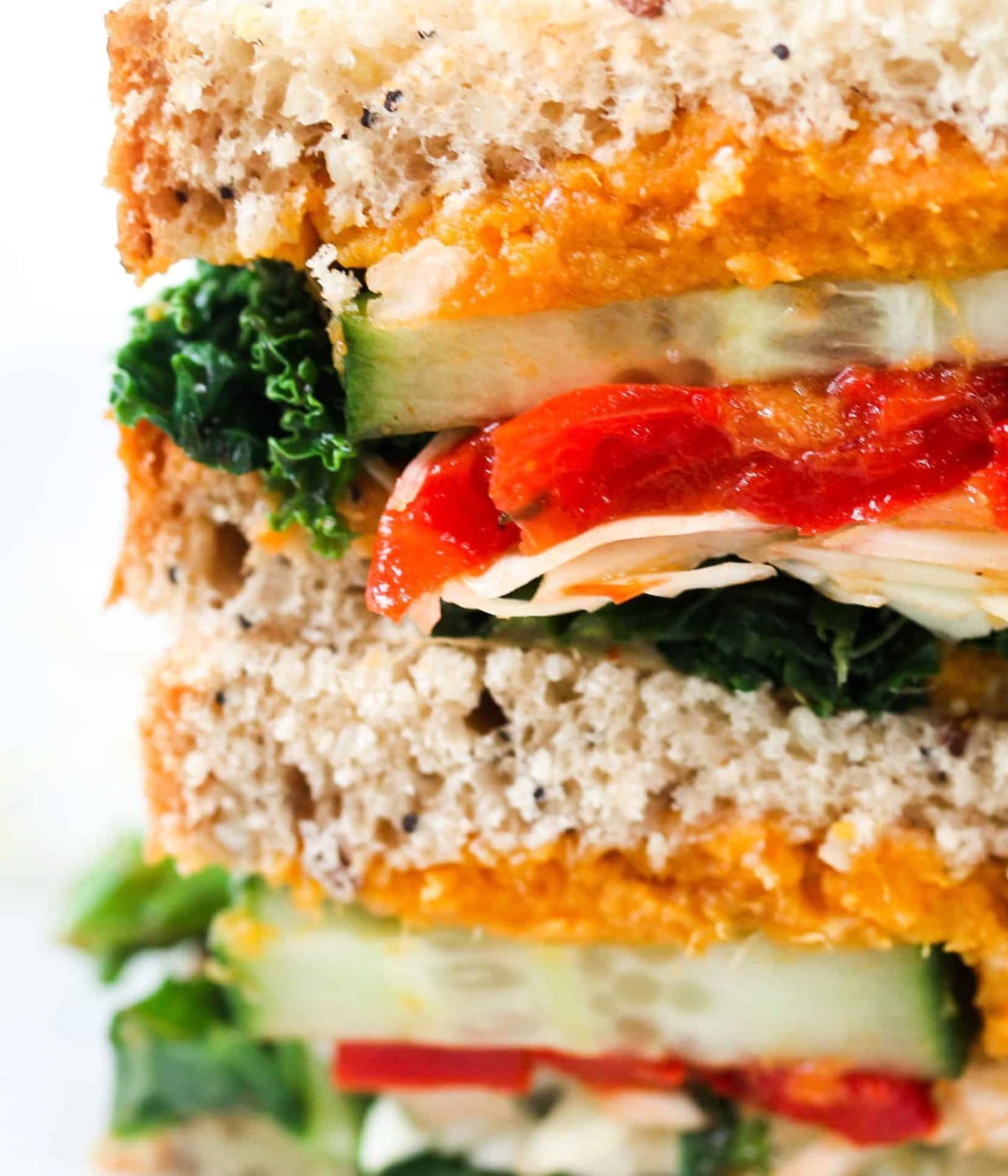 Sandwhich filled with sweet potato, kale, cucumber, red bell pepper and cabbage.