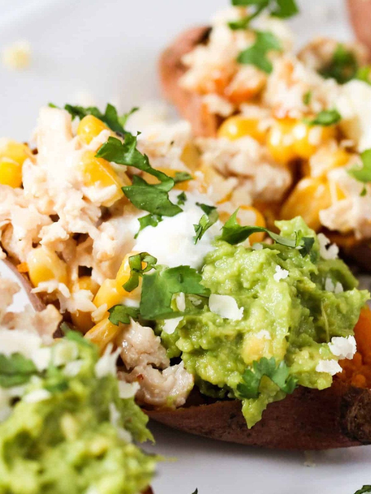Chicken loaded sweet potato with guacamole, corn and sour cream.