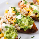 Chicken, mayo and sweetcorn in a sweet potato. Topped with guacamole, fresh herbs and sour cream.