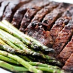 Sliced cooked beef and asparagus.
