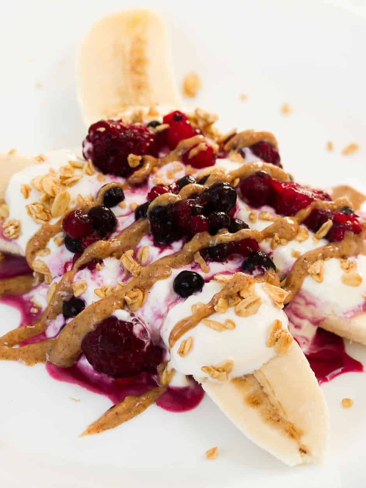 Bananas topped with yogurt, almond butter and berries.