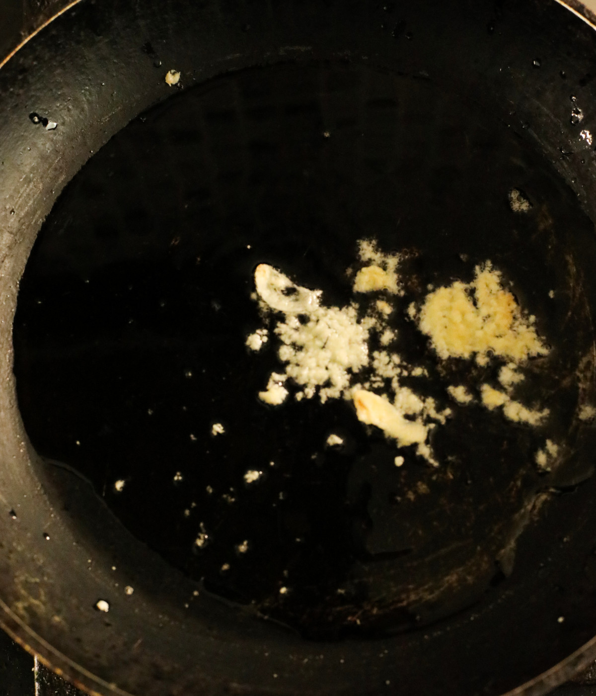 Butter and minced garlic in a black pan.