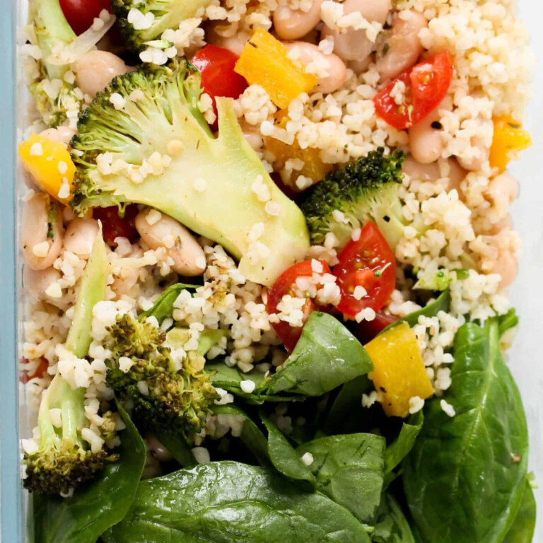 Quinoa, broccoli, tomato, cannoli, spinach and yellow capsicum peppers.