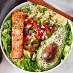 Salmon, lettuce, avocado, bulgur, capsicum peppers and lemon.