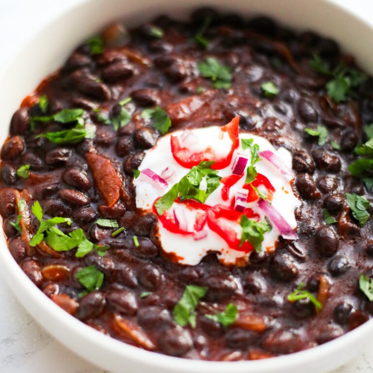 Stewed black beans and sour cream.