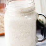 Banana, oat milk mixture in a glass jar.