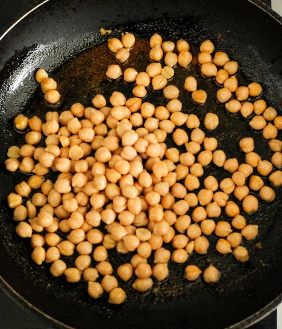 Chickpeas in a black pan.