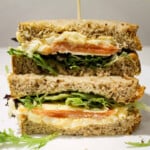 Mashed boiled eggs with mayo, salmon and rocket in a sandwich.