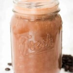 Mocha, milk mixture in a glass jar.