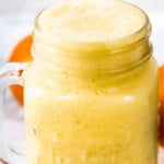 Orange, pineapple mixture in a glass jar.