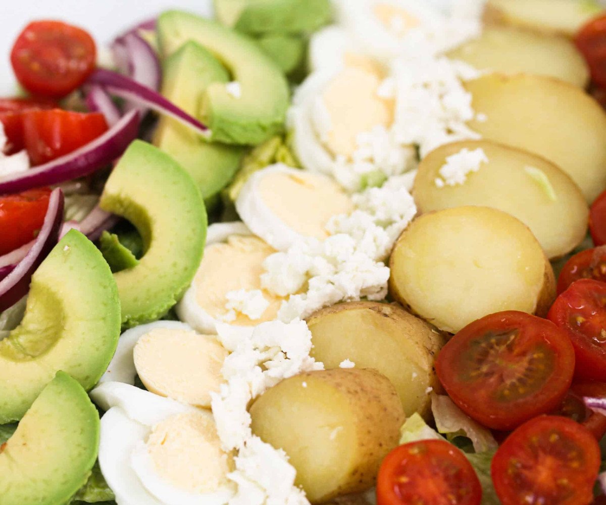 Tomatoes, avocado, boiled egg, cheese and red onions.