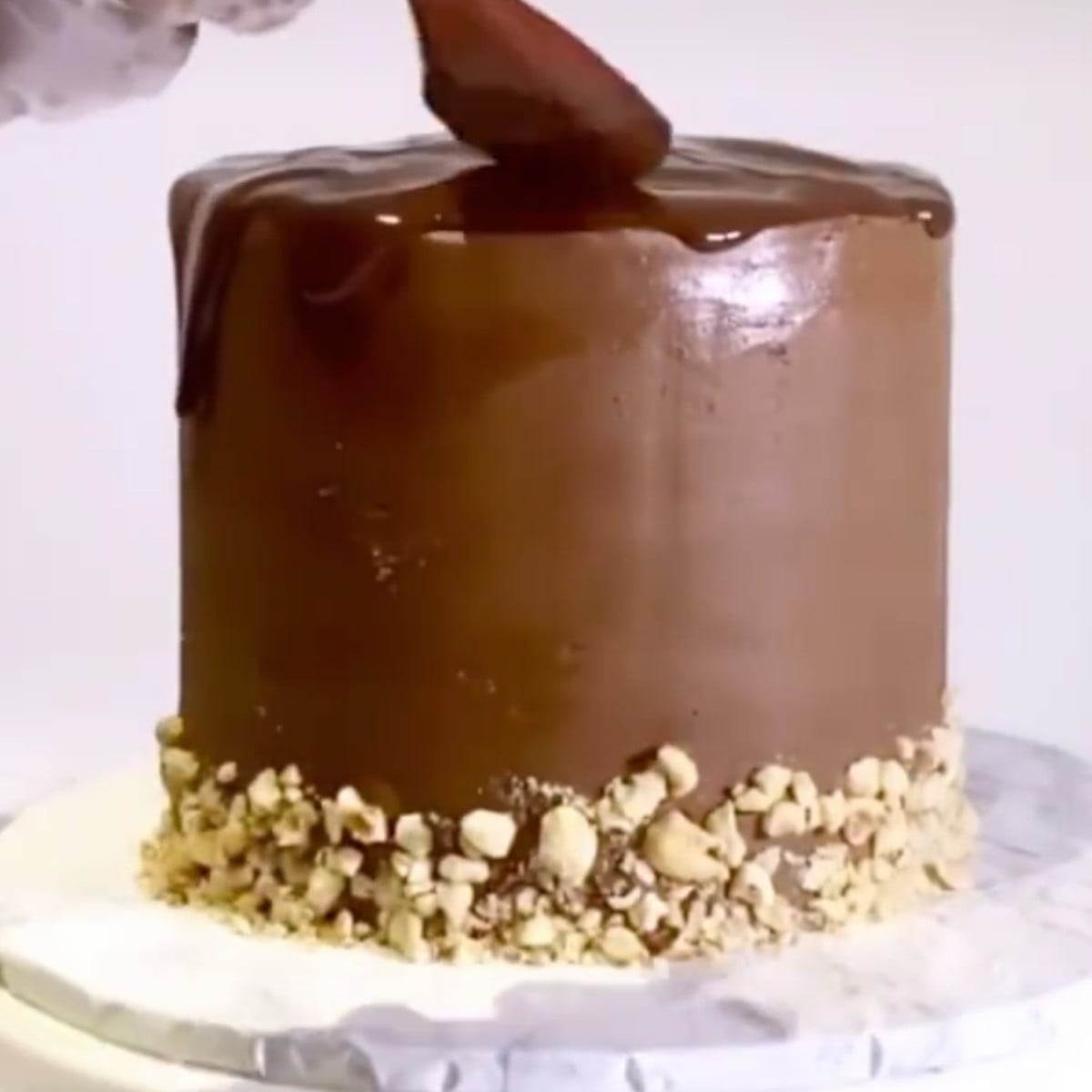 Chocolate ferrero cake with milk chocolate ganache, crushed hazelnuts.