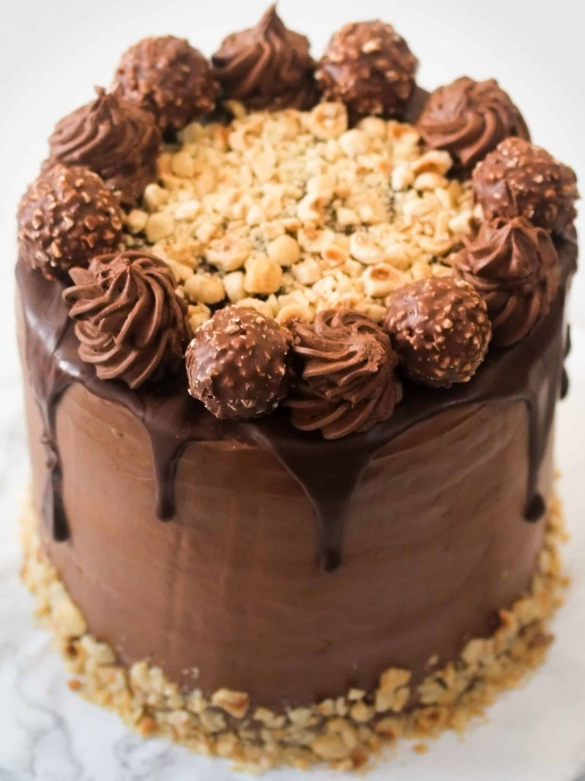 Ferrero rocher cake with chocolate gamache and hazelnuts.