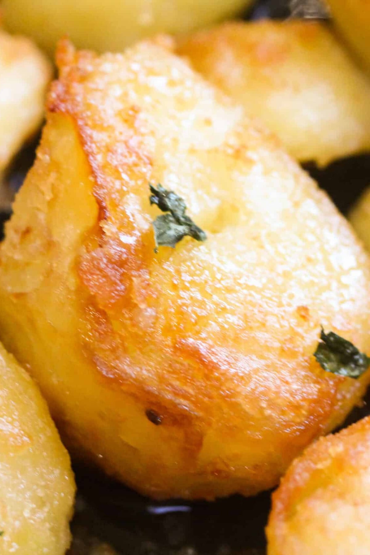 Roast potato with a herb on top.