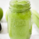 Apple, celery, avocado and milk mixture in a glass jar.