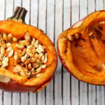 Baked whole pumpkin on an oven rack.