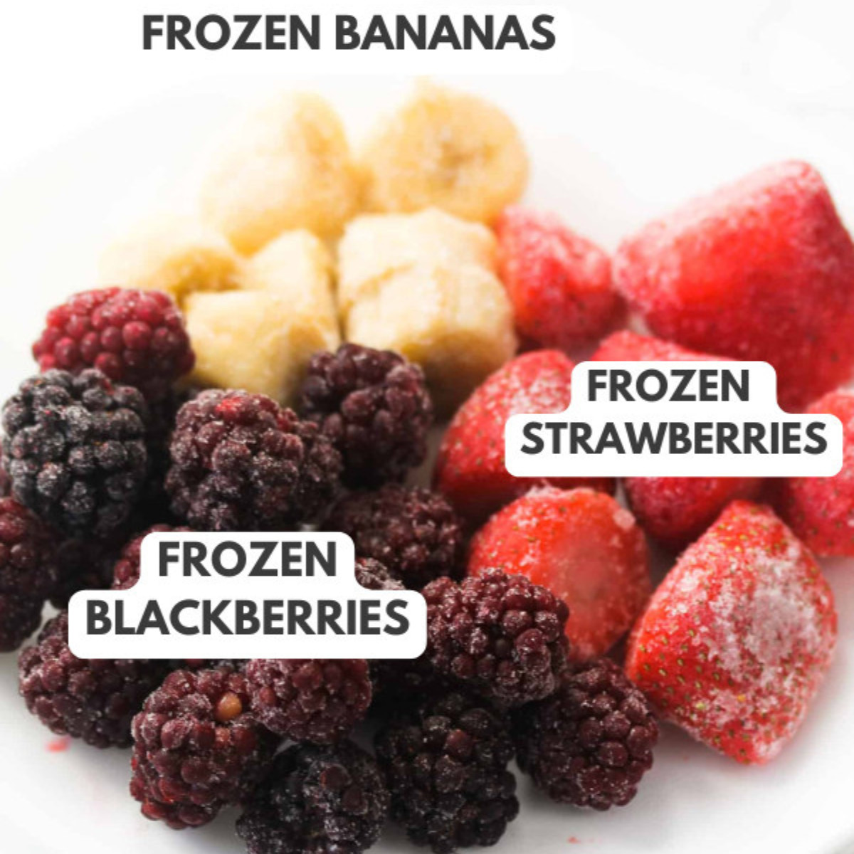Frozen bananas, frozen strawberries and frozen blackberries in a white plate.
