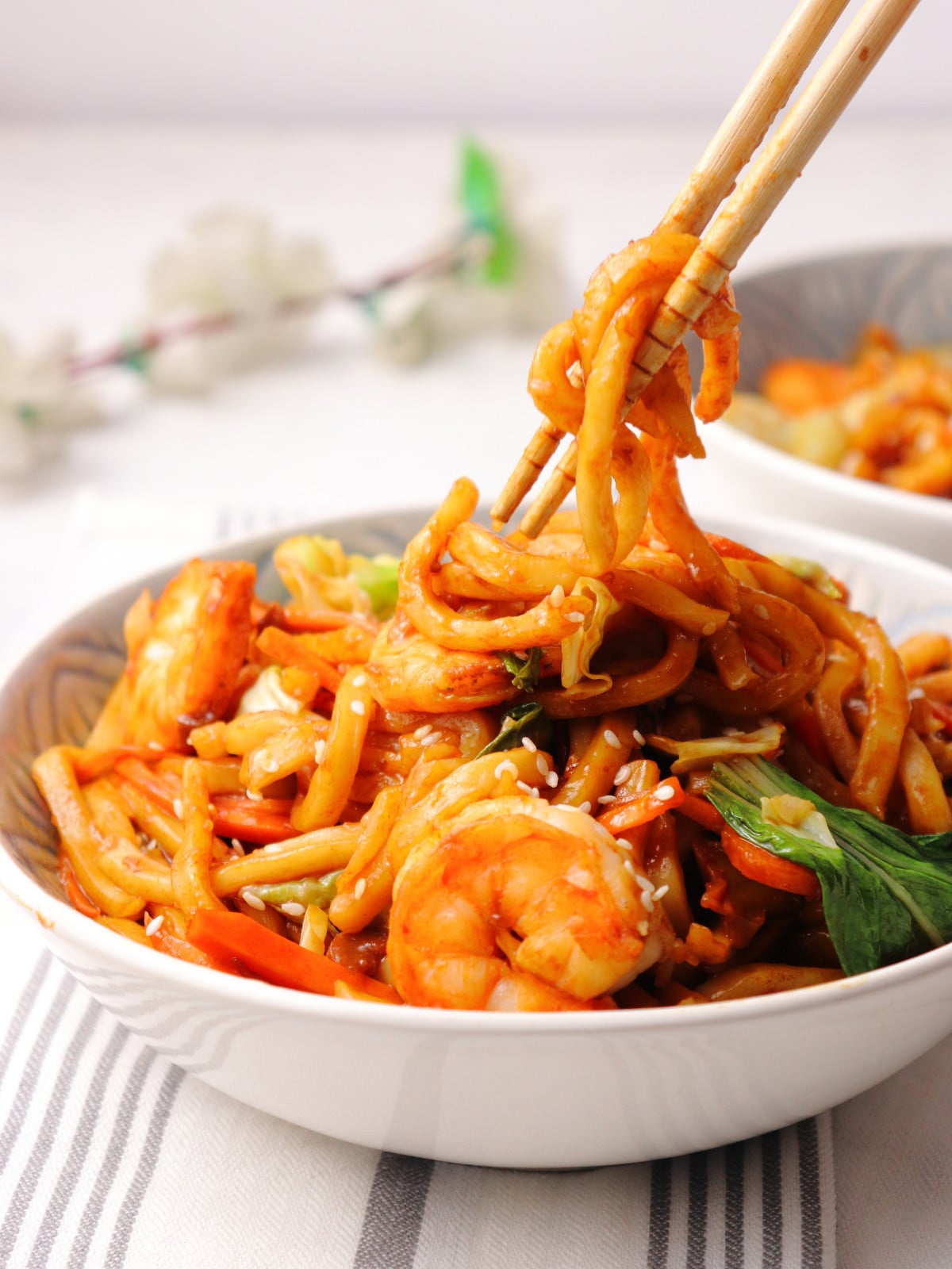 Prawn yaki udon in a bowl with chopsticks.
