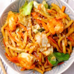Prawn yaki udon noodles in a bowl woth carrots and cabbage.