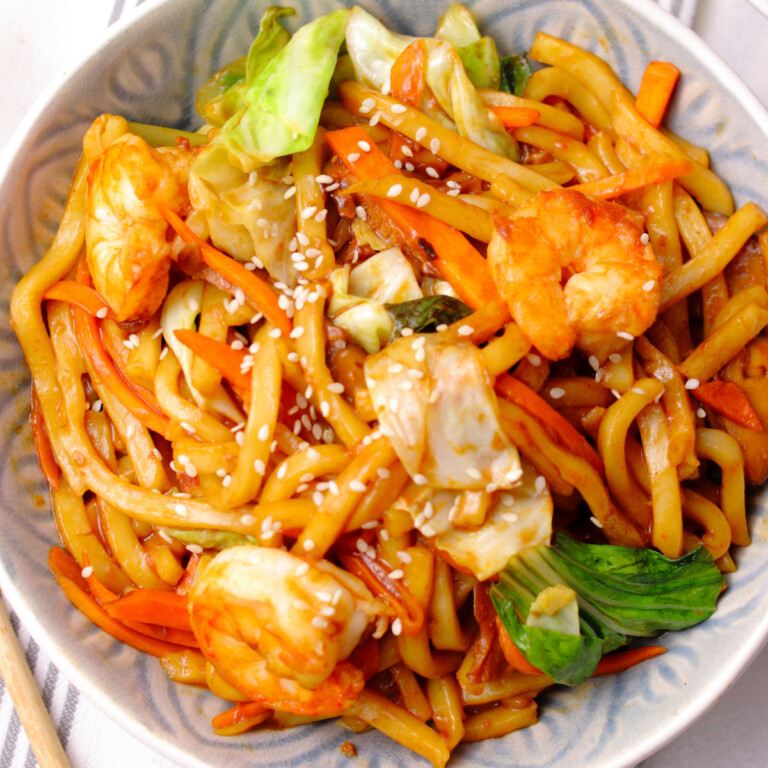 Prawn yaki udon noodles in a bowl woth carrots and cabbage.