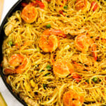 Singapore shrimp vermecelli in a black pan.