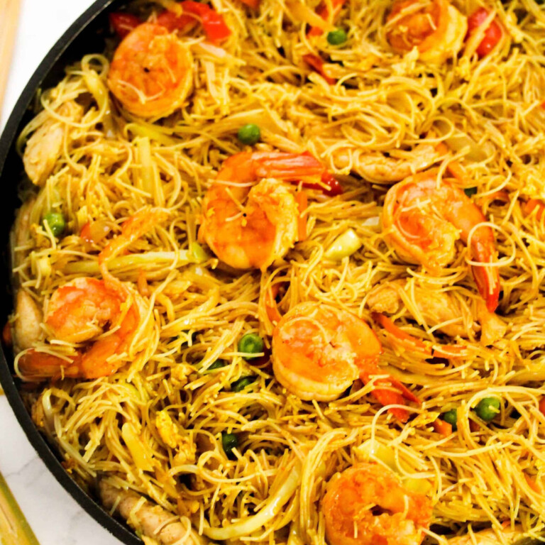 Singapore shrimp vermecelli in a black pan.