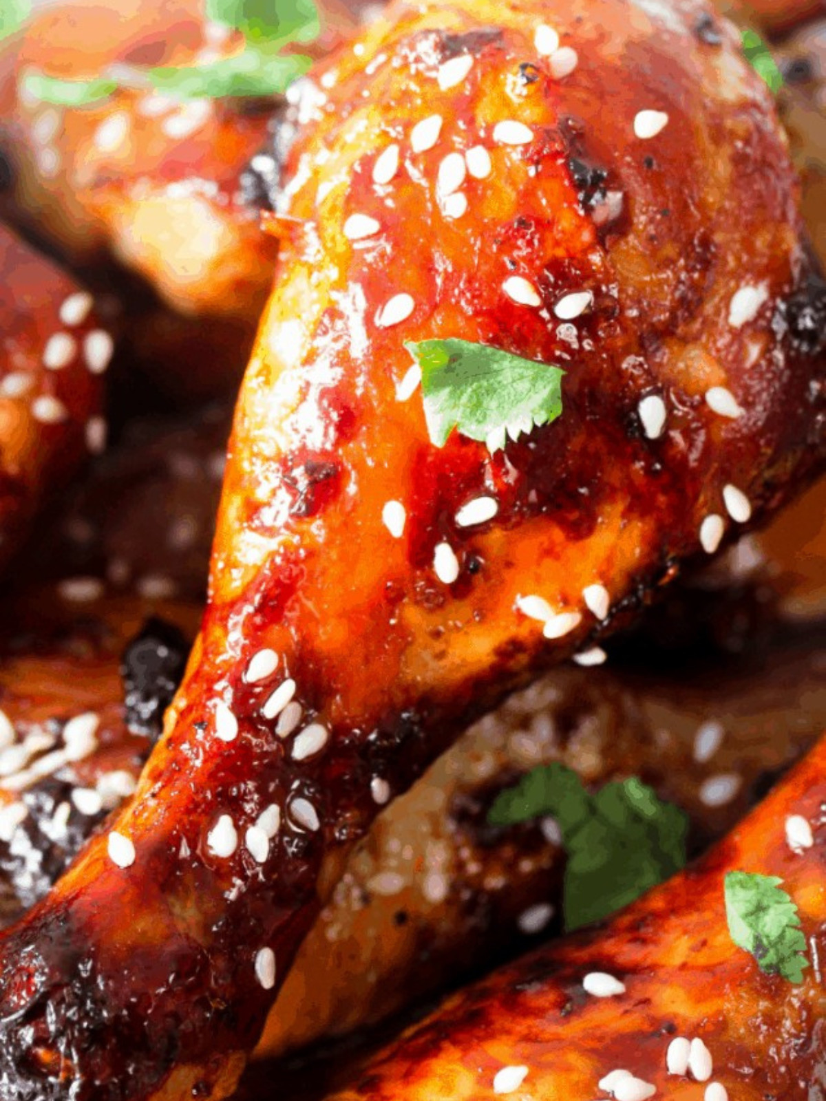 Honey soy drumsticks topped with sesame seeds and parsley.