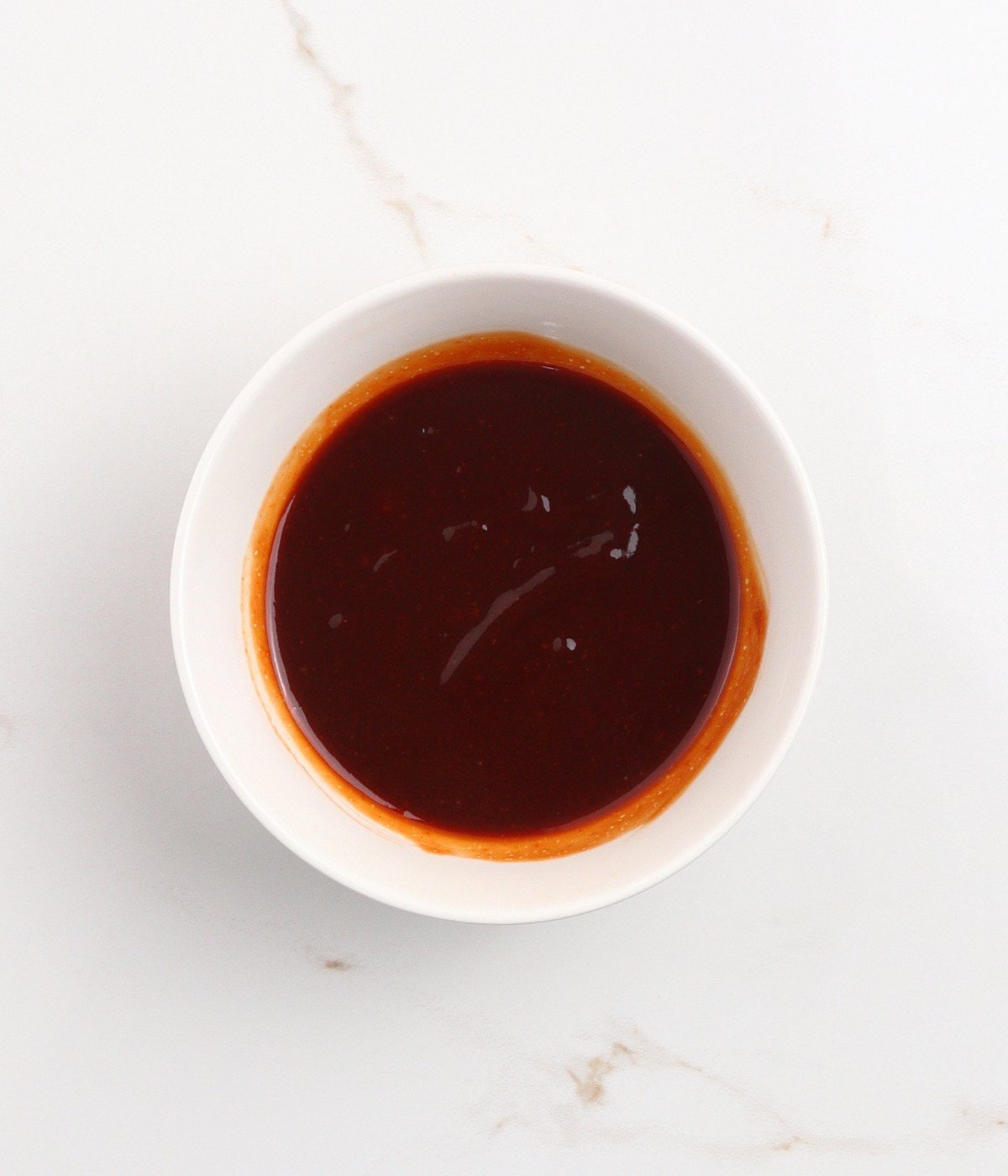 Soy sauce, ketchup, brown sugar and vinegar in a bowl.
