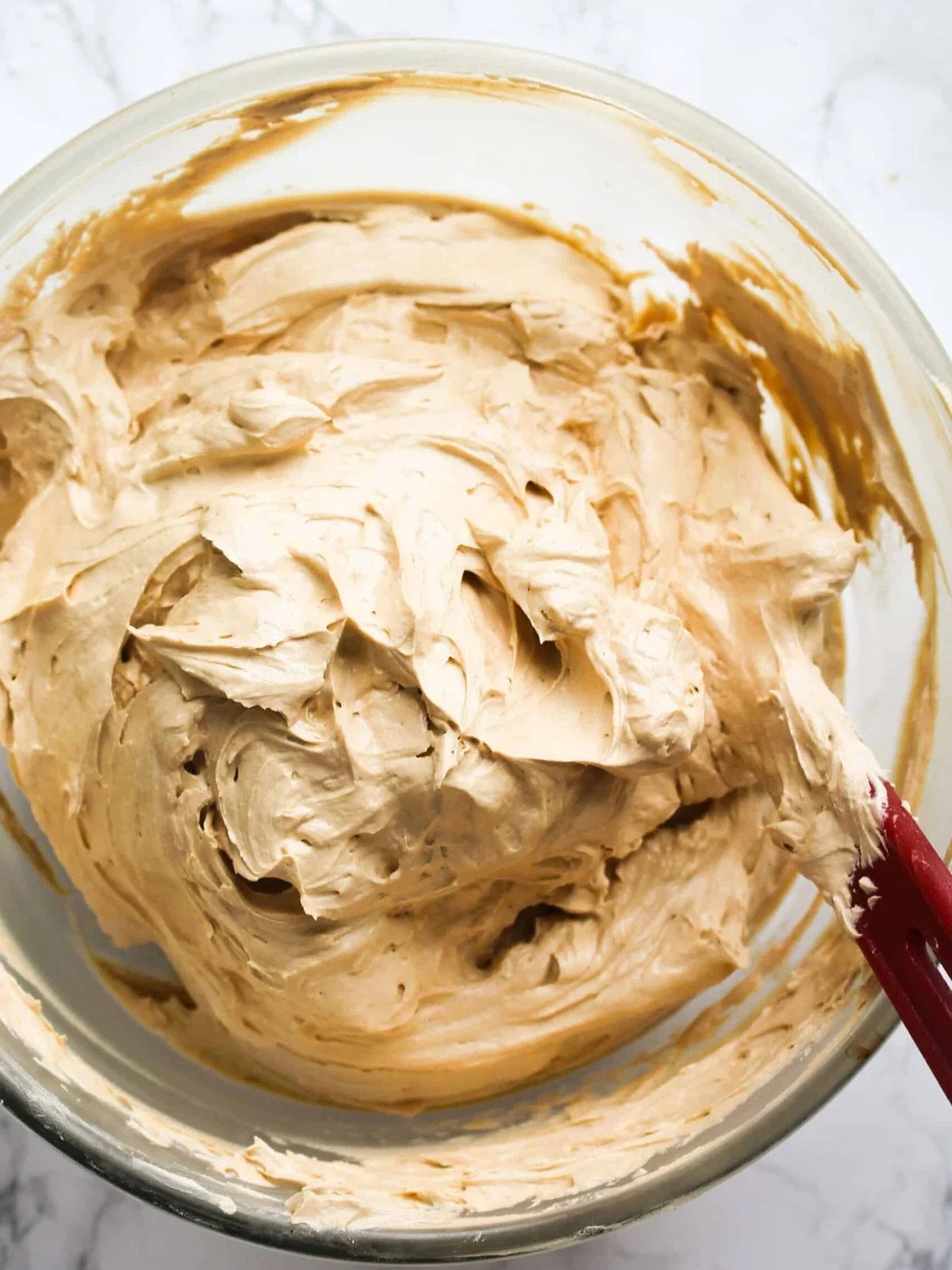 Espresso frosting in a glass bowl.