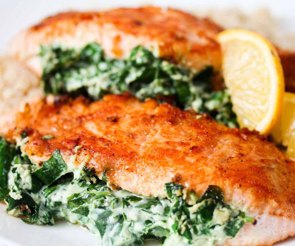 Salmon with Ricotta and Spinach and a lemon wedge.