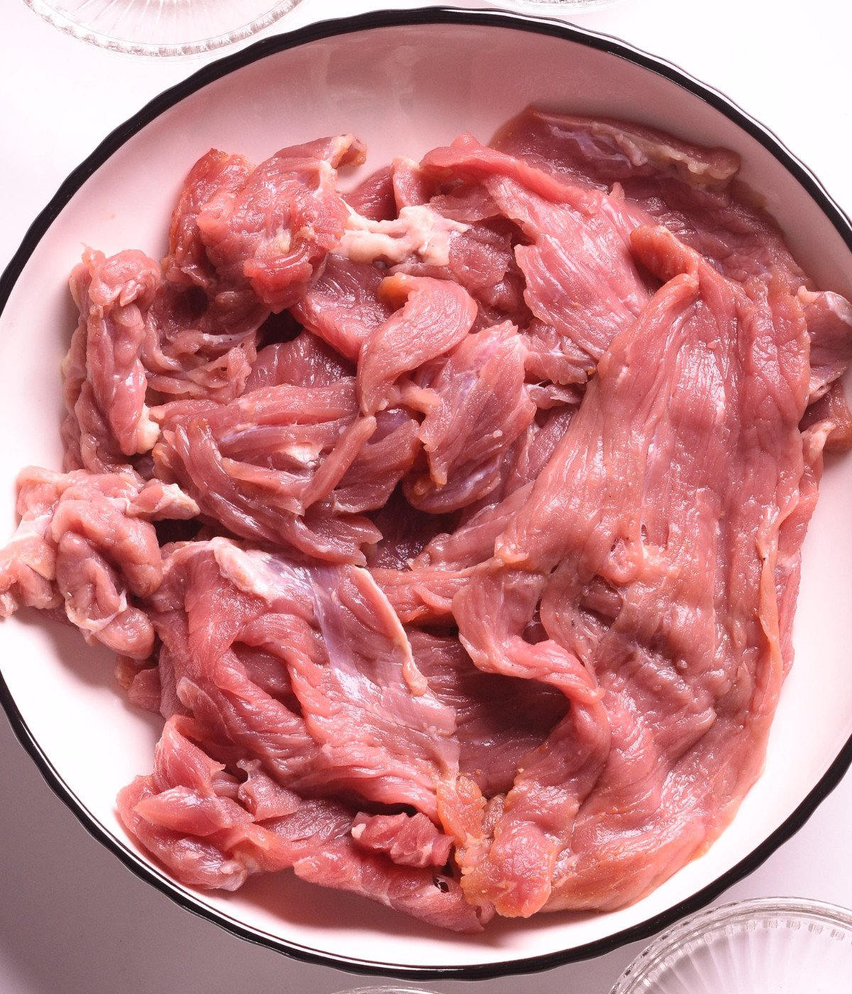 Sliced flank steak in a white plate.
