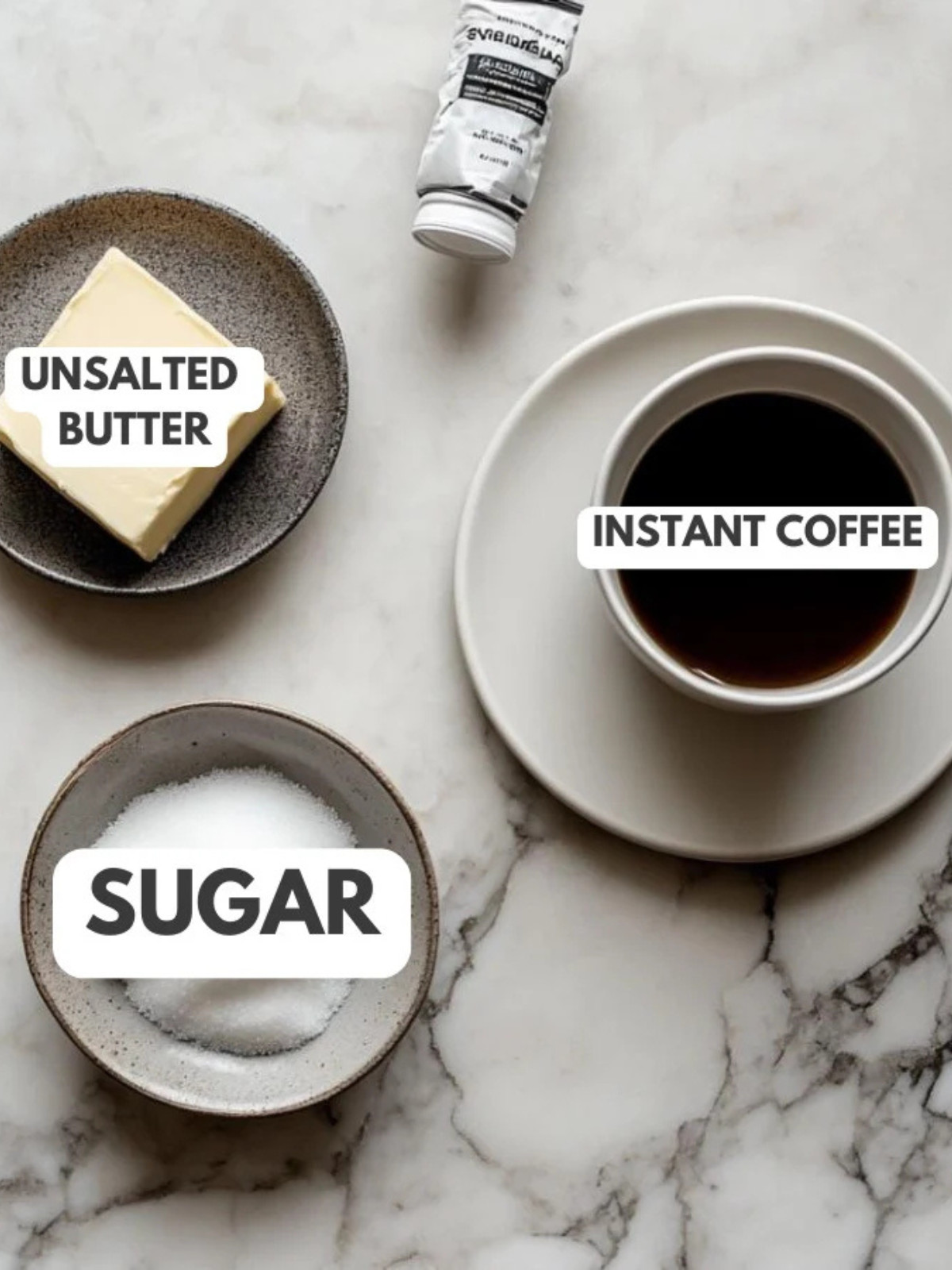 Unsalted butter, sugar and coffee on a table.