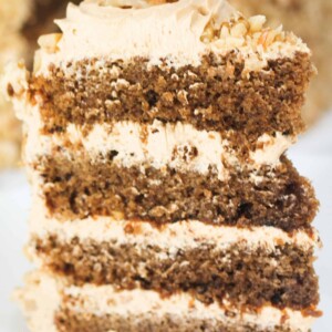 a slice of four layer coffee and walnut cake