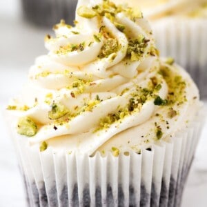 Chocolate cupcakes with crushed pistachio and cognac buttercream frosting