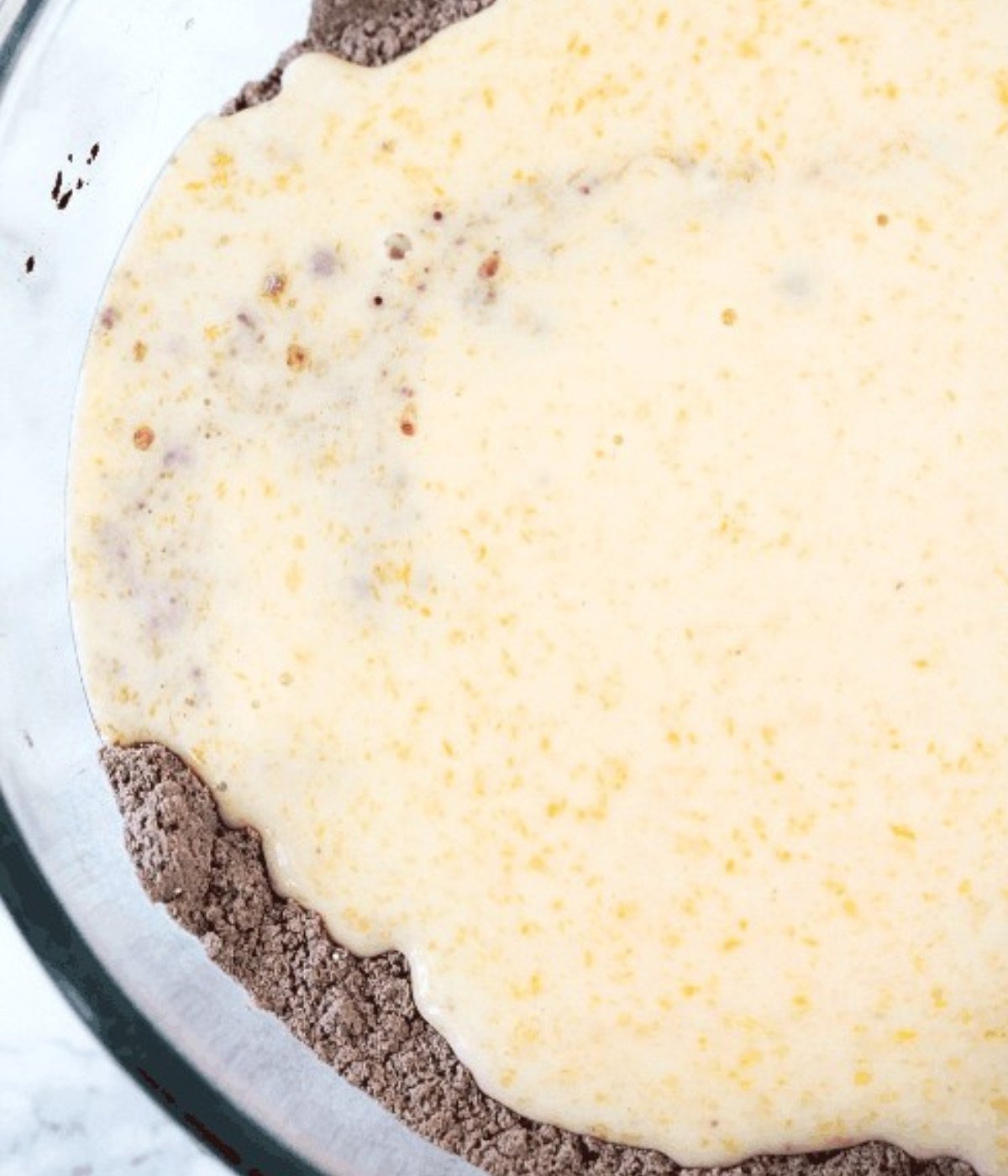 Cocoa powder, flour, milk and eggs in a bowl.