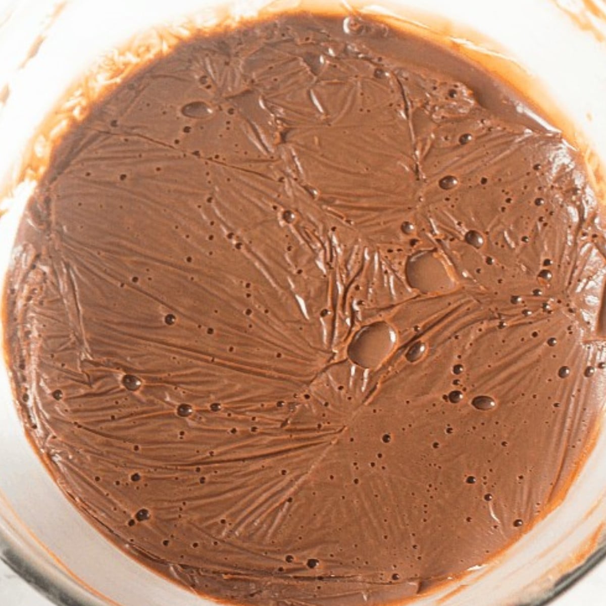 Hardened milk chocolate in a glass bowl.