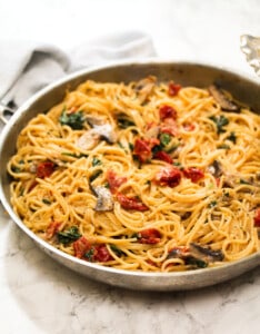 creamy mushroom, sun-dried tomatoes, spinach pasta in a pan side view