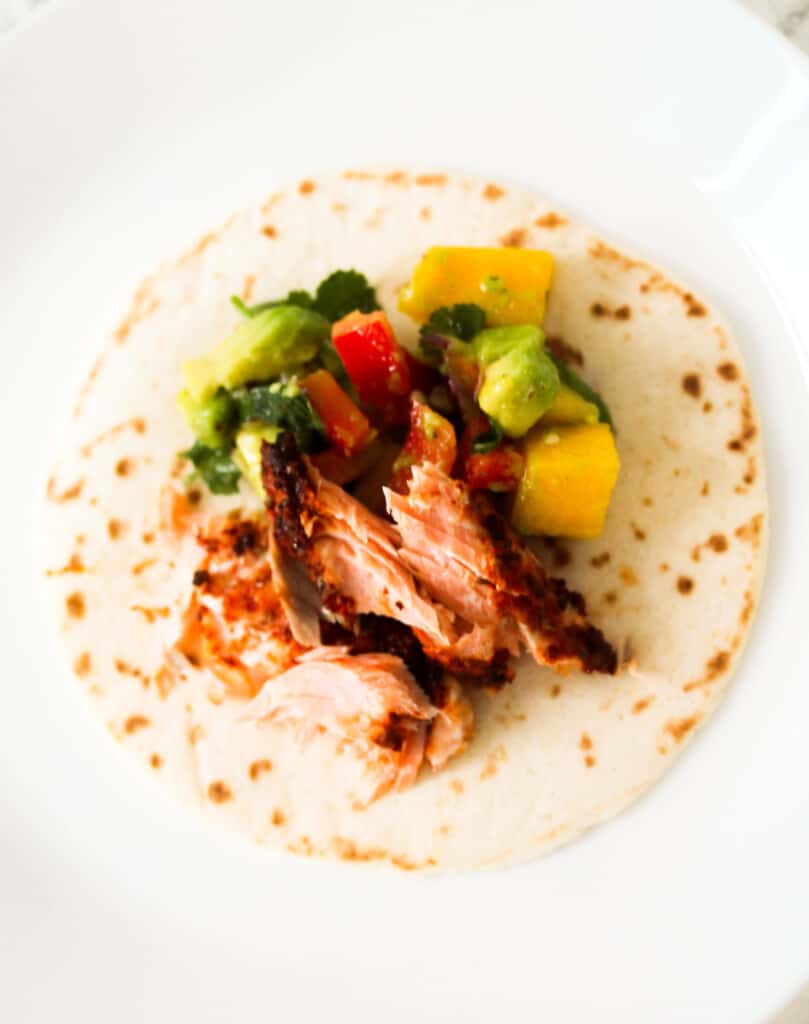 assembled salmon taco with mango salsa